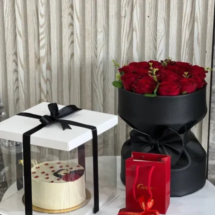 A bouquet of roses & a cake box with a gift necklace