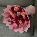 A bouquet of mixed roses and pink tulips
