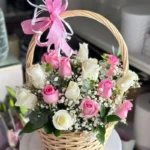 A basket of white roses and flowers with charming gypsophila blossoms