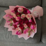 A bouquet of mixed roses and pink tulips