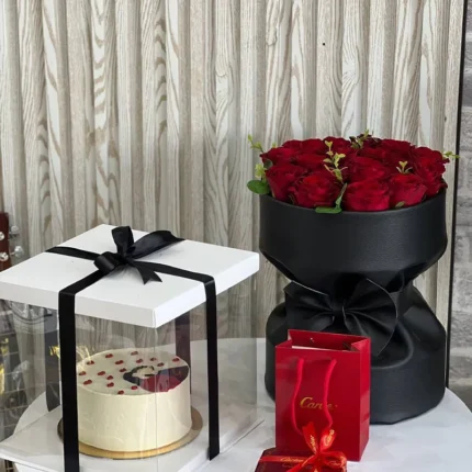 A bouquet of roses & a cake box with a gift necklace