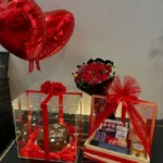 A bouquet of roses with a chocolate cake